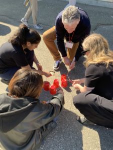 Students and educators working on a task involving cups