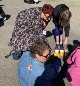 Students and educators working on a task involving cups